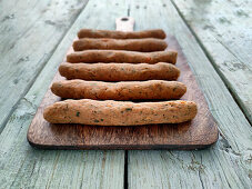Vegan sausages on wooden cutting board