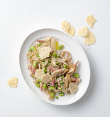 Spelt tagliatelle with peas, broad beans, and artichokes served with pecorino chips