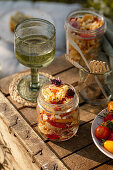 Pasta salad in glass jars for a picnic