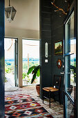 Colourful rug on recycled floor tiles in hall