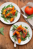 Bacon wrapped pumpkin slices served on arugula with sage leaves