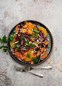 Roasted pumpkin salad with segmented orange slices and goat cheese