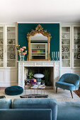 Elegant seating area with upholstered furniture and fireplace flanked by display cabinets