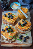Whole grain bread with red lentil spread and black olives