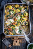 Potatoes, fish, mushrooms and spinach bake