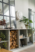 Houseplants and mirror on top of sideboard with firewood compartment