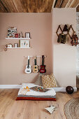 Play area, guitar collection and wall-mounted shelves in nursery with high wooden ceiling