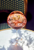 Aperol Spritz with ice cubes on an outdoor table