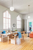 Dining area with wooden benches in converted chapel