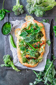 Pizza with broccoli, peas and chicken