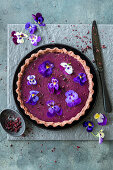 Berry ganache pie with violas