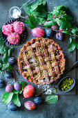 Plum and pistachio pie with lattice topping