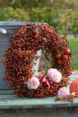Wreath of rose hips, rose petals and Virginia creeper leaves