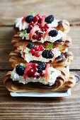 Eclairs with berries and cream