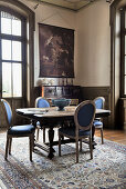 Antique wooden table with blue medallion chairs