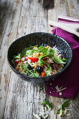 Rice salad with rocket, tomatoes and olives