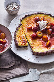 Coconut brûlée tart with caramelised plums