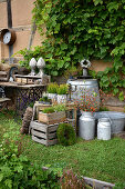 Boxes, wooden barrel and flea-market finds as rustic decorations in garden