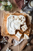 Coconut carrot cake with mascarpone coconut frosting, decorated with almond easter egg