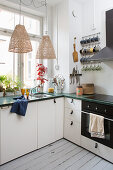 White kitchen with leather loop handles and floorboards