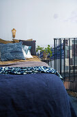 Patterned fabric in a bedroom in blue with banister to staircase