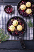 Vegan soy goulash with red cabbage, potato dumplings and cranberries