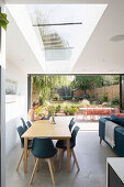 Dining area with woman seated at table and view into the garden