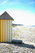 Yellow-white changing room on the beach