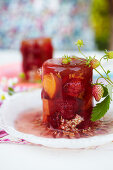 Strawberries, peaches, and raspberries in elderflower jelly