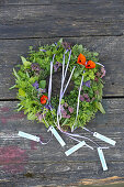 Scented wreath with herb blossoms and marigolds