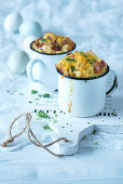Small egg gratin with bacon and herbs