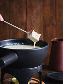 Cheese fondue with bread cubes for dipping