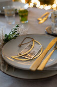 Christmas place setting with golden cutlery and old photo