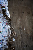 Larch branch with cones on rustic wooden table