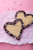 Vegan vanilla shortcrust hearts with plain icing and sprinkles