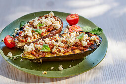 Grilled aubergine halves with pesto rosso and feta cheese
