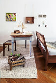 Table, stool and double bed in studio apartment