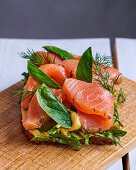 An open sandwich with smoked salmon, spinach and dill