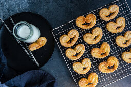 Traditional Puff pastry spiral biscuits known as a pig's ears on plate with sugar
