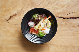 Ramen with udon noodles, salad, egg, tempura prawns and spring onion