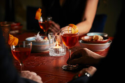 A dinner party with negronis