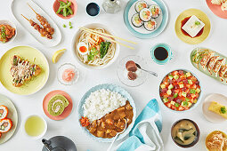 Elegantly laid table full of Japanese dishes (filling the frame)