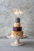 Cheese Wedding Cake - wheels of Cheeses arranged as a tiered wedding cake, with sparklers