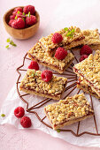 Oatmeal raspberry jam bars with crumb topping on a cooling rack
