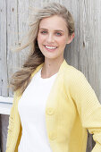 Boy, blonde woman in white top and yellow cardigan