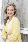 Boy, blonde woman in white top and yellow cardigan