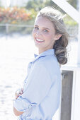 Young, blond woman in light blue shirt blouse