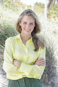 Boy, blond woman in yellow blouse and green shorts