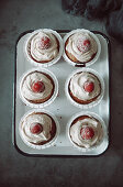 Cupcakes with frosting and raspberry on top