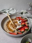 Plate of strawberry porridge on a table in the kitchen